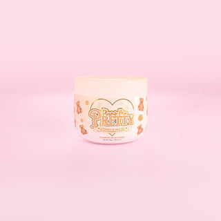 Jar of P.Louise Plump Me Pretty coconut cake moisturiser on a pink background