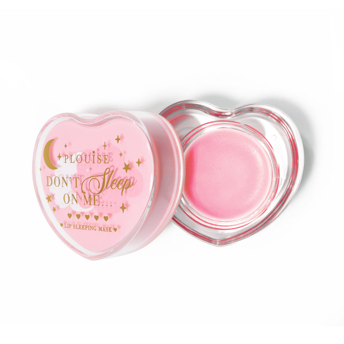 Pink heart-shaped lip sleeping mask with the lid off on a white background