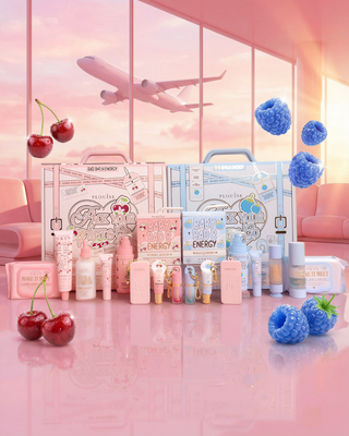 Collection of skincare and lipcare products with cherry blossom and blue raspberry decorations on a pink background.